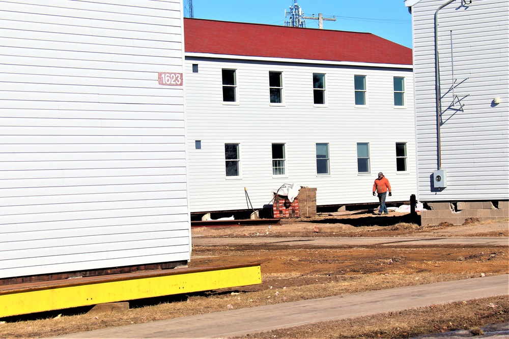 Contractors moving four World War II-era barracks buildings at Fort McCoy