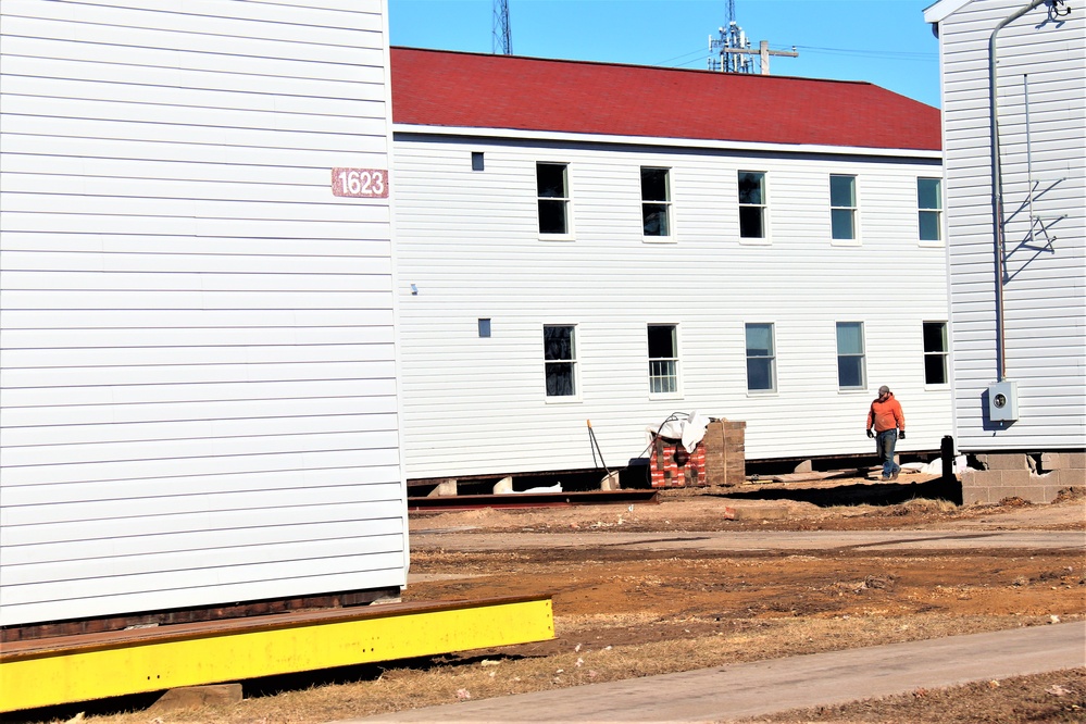 Contractors moving four World War II-era barracks buildings at Fort McCoy