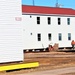 Contractors moving four World War II-era barracks buildings at Fort McCoy