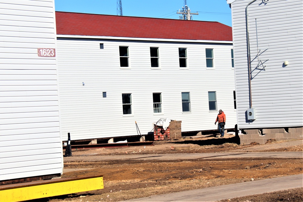 Contractors moving four World War II-era barracks buildings at Fort McCoy