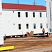 Contractors moving four World War II-era barracks buildings at Fort McCoy