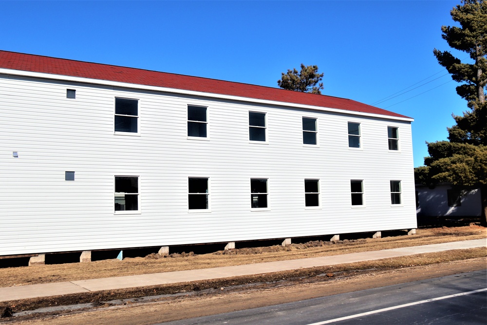 Contractors moving four World War II-era barracks buildings at Fort McCoy