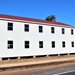 Contractors moving four World War II-era barracks buildings at Fort McCoy