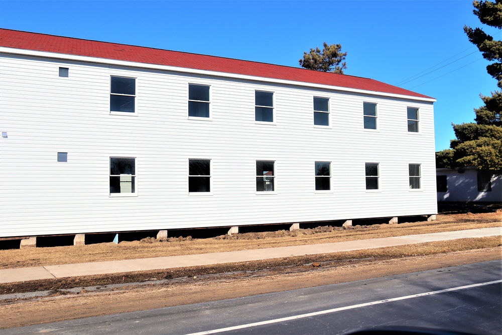 Contractors moving four World War II-era barracks buildings at Fort McCoy