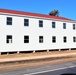 Contractors moving four World War II-era barracks buildings at Fort McCoy