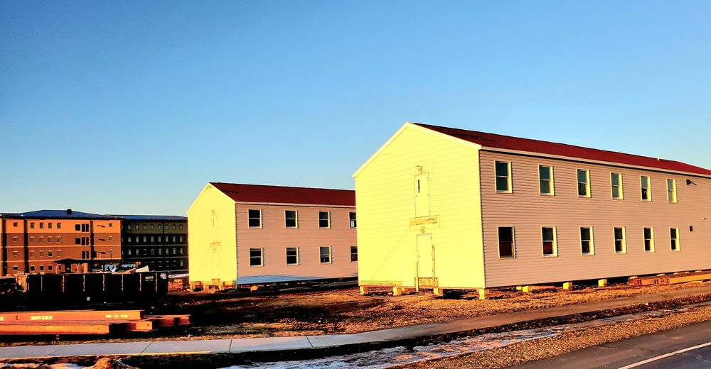 Contractors moving four World War II-era barracks buildings at Fort McCoy