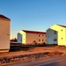 Contractors moving four World War II-era barracks buildings at Fort McCoy