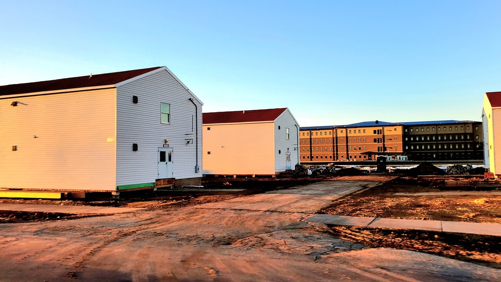 Contractors moving four World War II-era barracks buildings at Fort McCoy