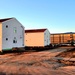 Contractors moving four World War II-era barracks buildings at Fort McCoy