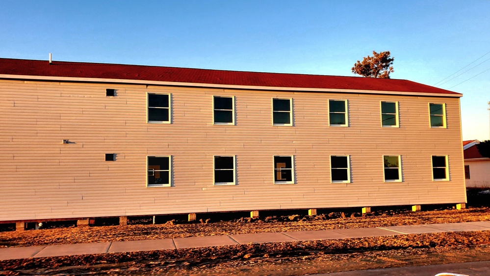 Contractors moving four World War II-era barracks buildings at Fort McCoy