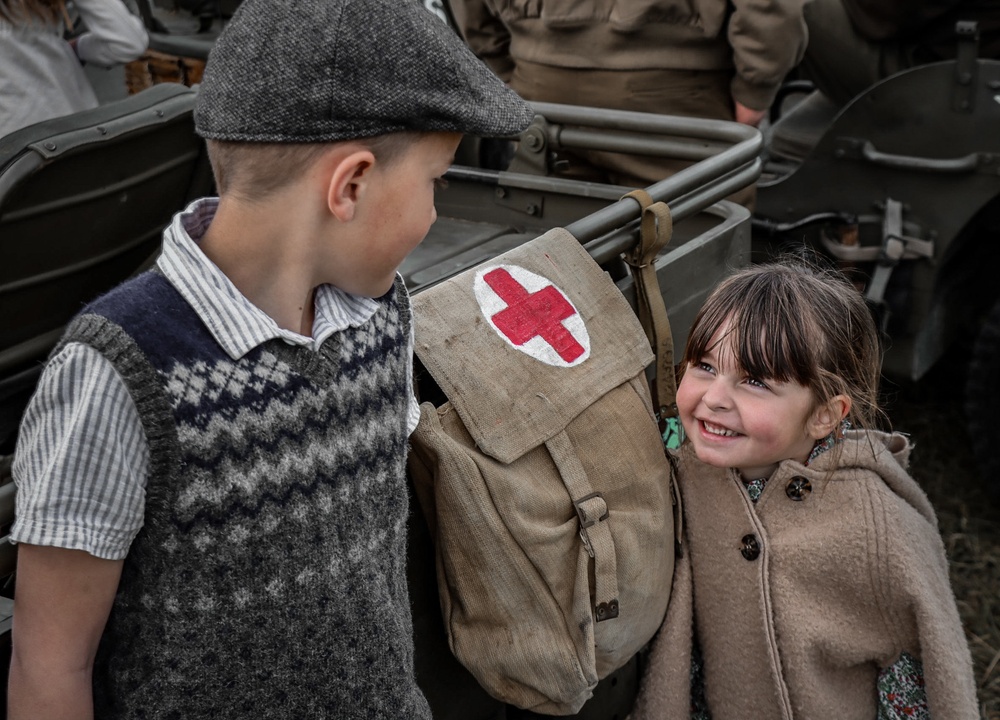 Soldiers and civilians gather at Airstrip to welcome D-Day Veterans