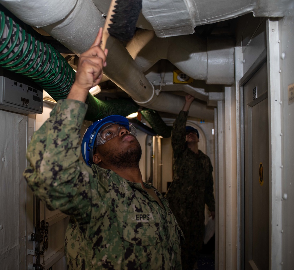 USS Ronald Reagan (CVN 76) Sailors conduct light fixture maintenance