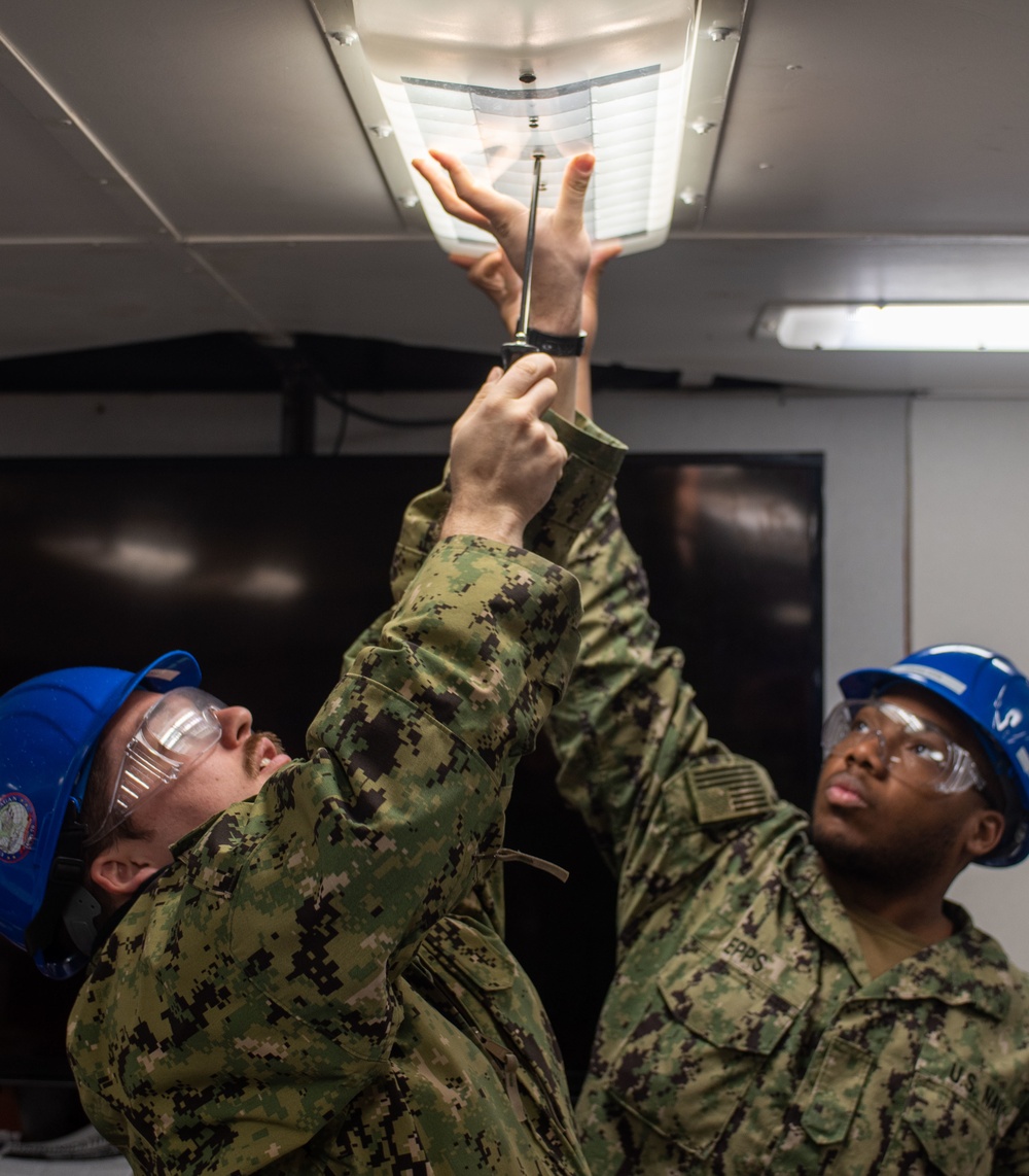 USS Ronald Reagan (CVN 76) Sailors conduct light fixture maintenance