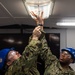 USS Ronald Reagan (CVN 76) Sailors conduct light fixture maintenance