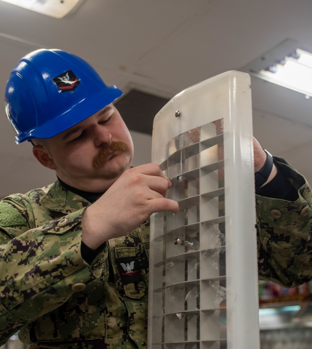 USS Ronald Reagan (CVN 76) Sailors conduct light fixture maintenance