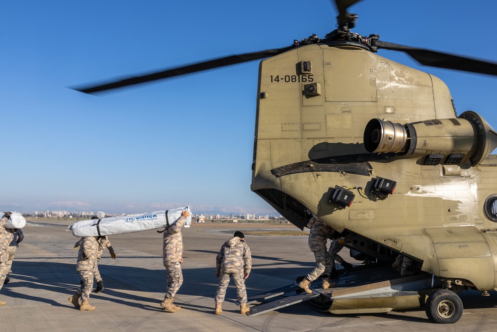 A US Army CH-47 Chinook is loaded with humanitarian aid supplies