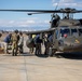 A US Army UH-60 Blackhawk is loaded with humanitarian aid supplies