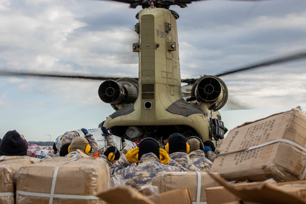 A US Army CH-47 Chinook is loaded with humanitarian aid supplies