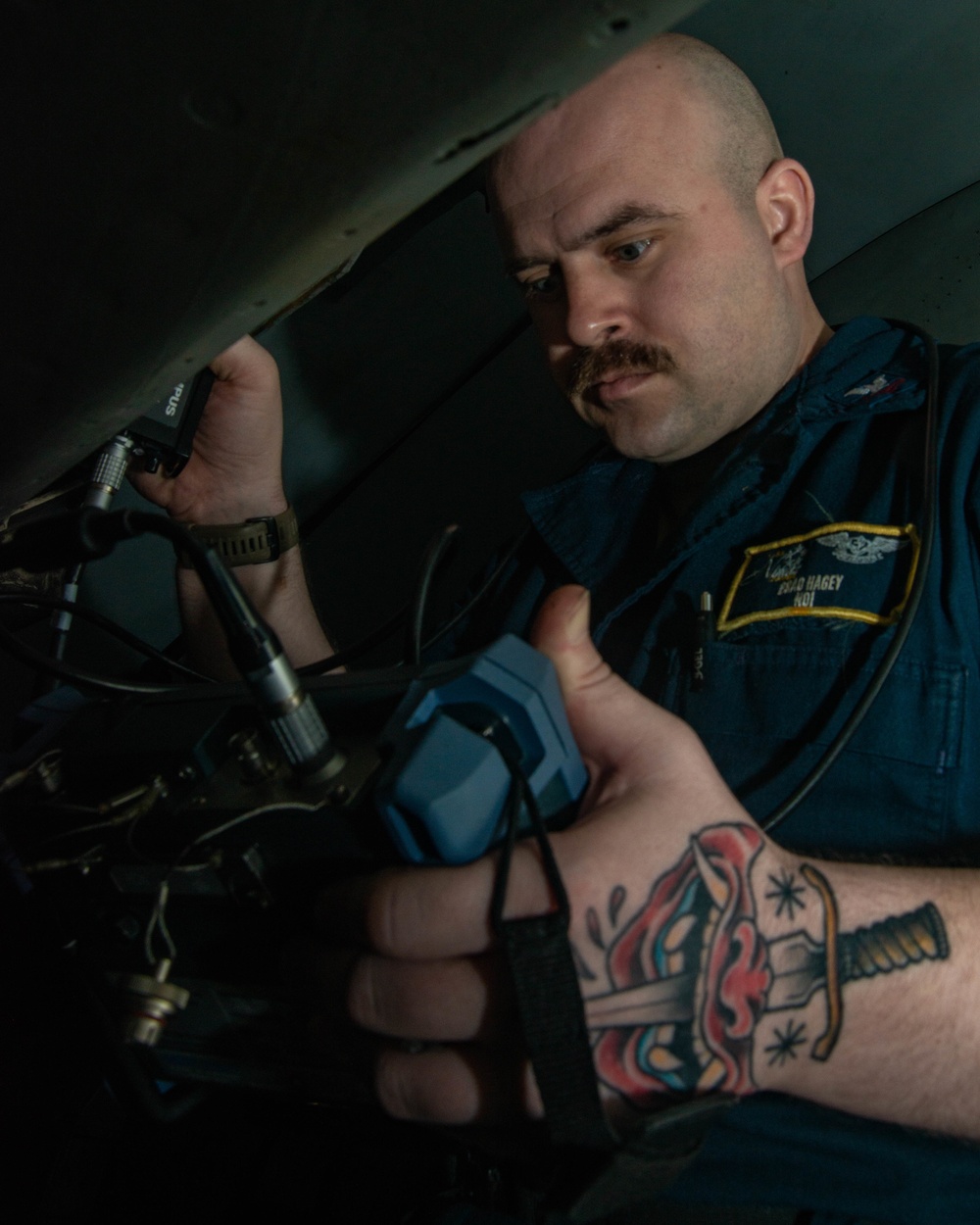 Sailor Inspects Aircraft Electronics