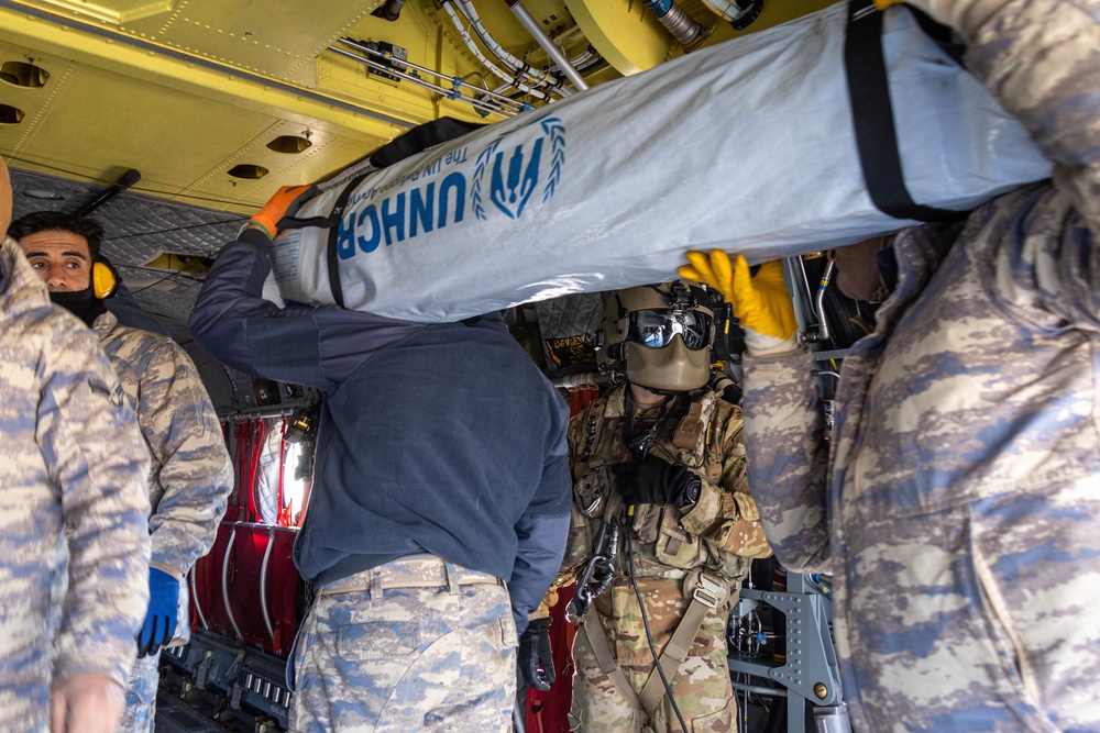 A US Army CH-47 Chinook is loaded with humanitarian aid supplies