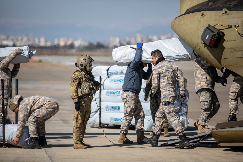 A US Army CH-47 Chinook is loaded with humanitarian aid supplies