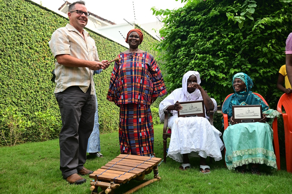 Members of USCGC Spencer (WMEC 905) celebrate Ensign Mohammad Diakite’s homecoming at his family’s home in Côte d’Ivoire