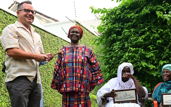 Members of USCGC Spencer (WMEC 905) celebrate Ensign Mohammad Diakite’s homecoming at his family’s home in Côte d’Ivoire