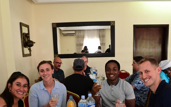 Members of USCGC Spencer (WMEC 905) celebrate Ensign Mohammad Diakite’s homecoming at his family’s home in Côte d’Ivoire