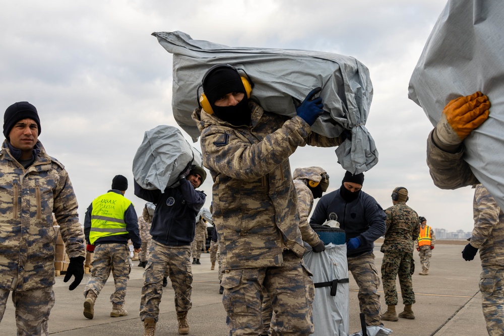 A US Army CH-47 Chinook is loaded with humanitarian aid supplies