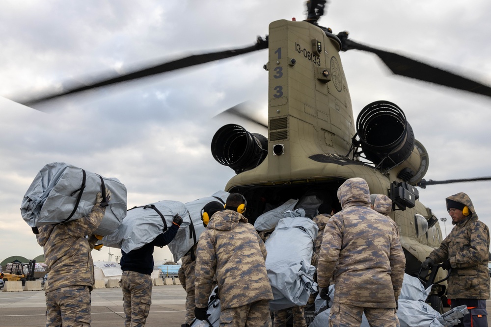 A US Army CH-47 Chinook is loaded with humanitarian aid supplies