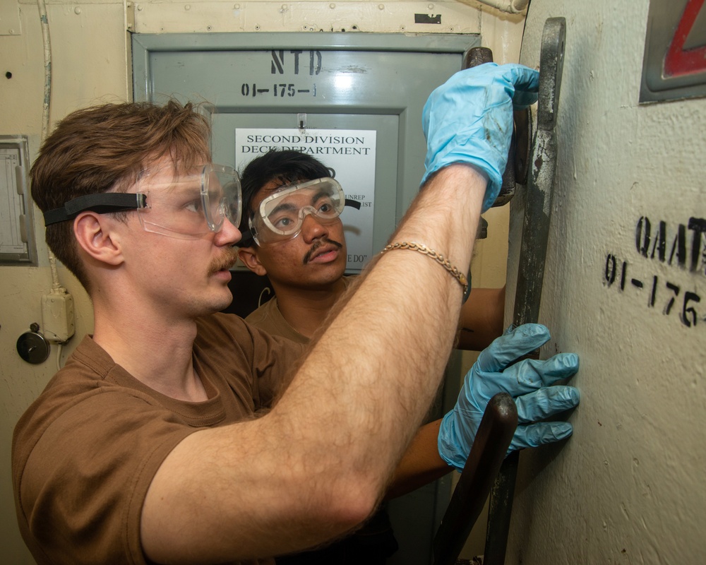 Sailors Conduct Maintenance On A Ballistic Door