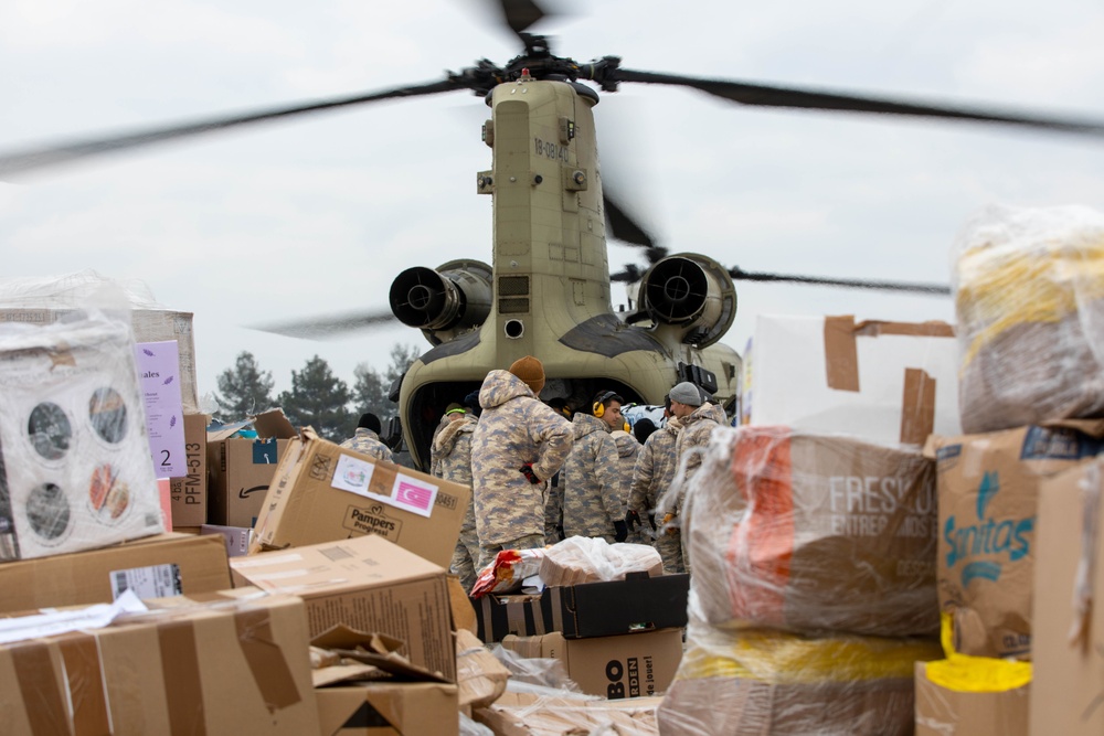 A US Army CH-47 Chinook is loaded with humanitarian aid supplies