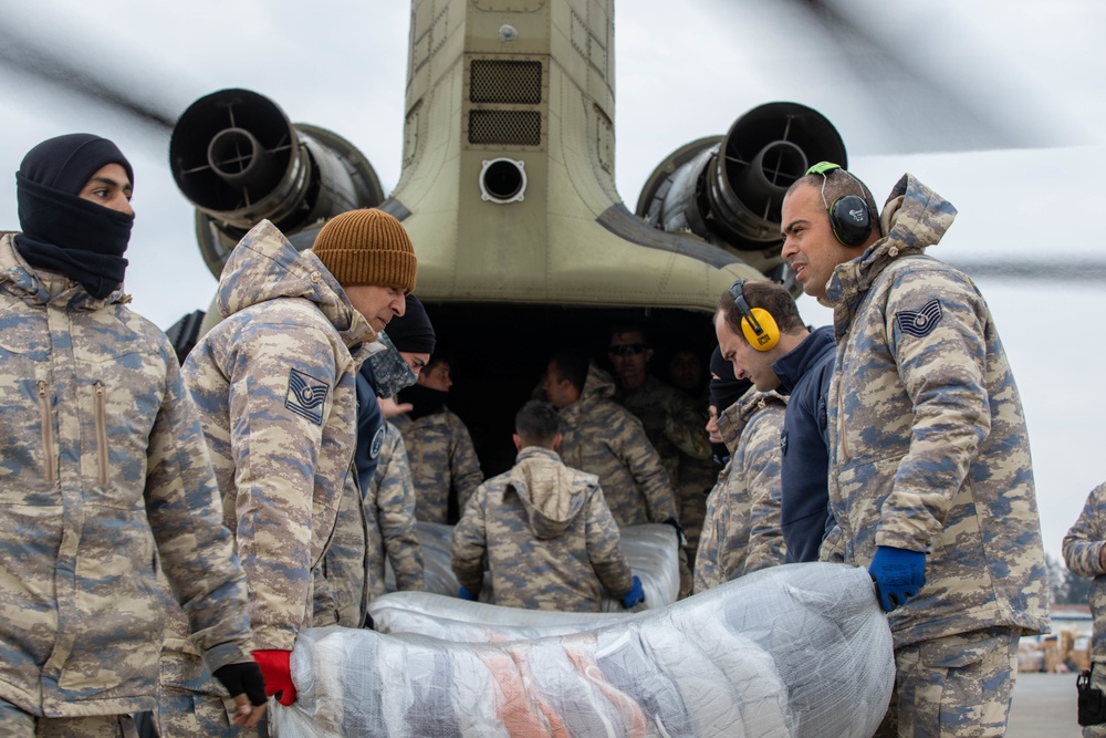 A US Army CH-47 Chinook is loaded with humanitarian aid supplies