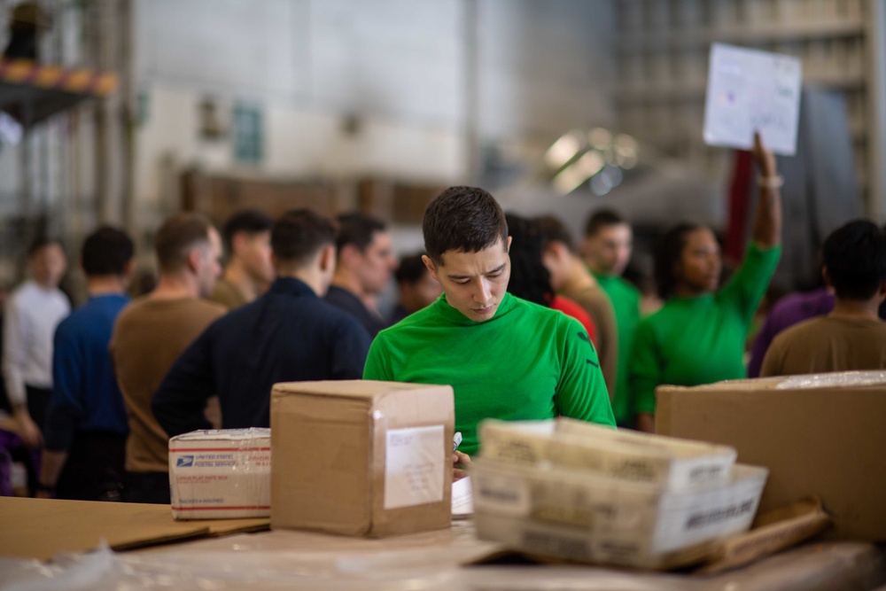 U.S. Navy Sailors Sort Mail During A Replenishment-At-Sea