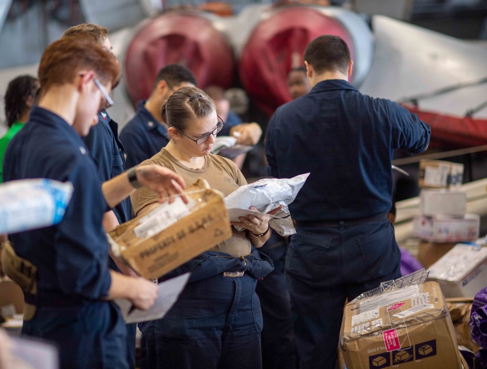 U.S. Navy Sailors Sort Mail During A Replenishment-At-Sea