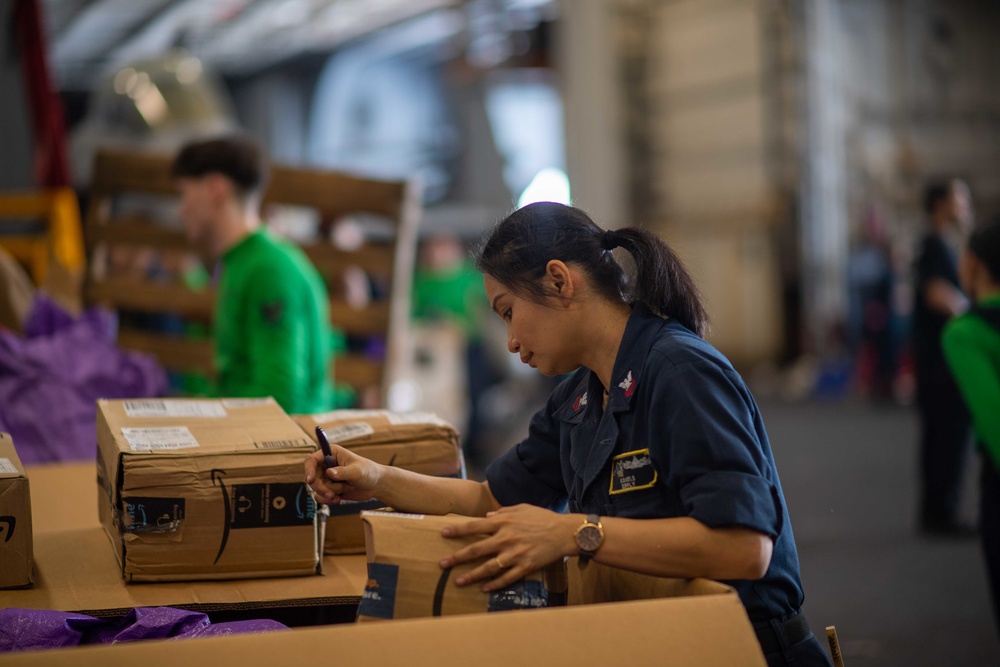 U.S. Navy Sailors Sort Mail During A Replenishment-At-Sea