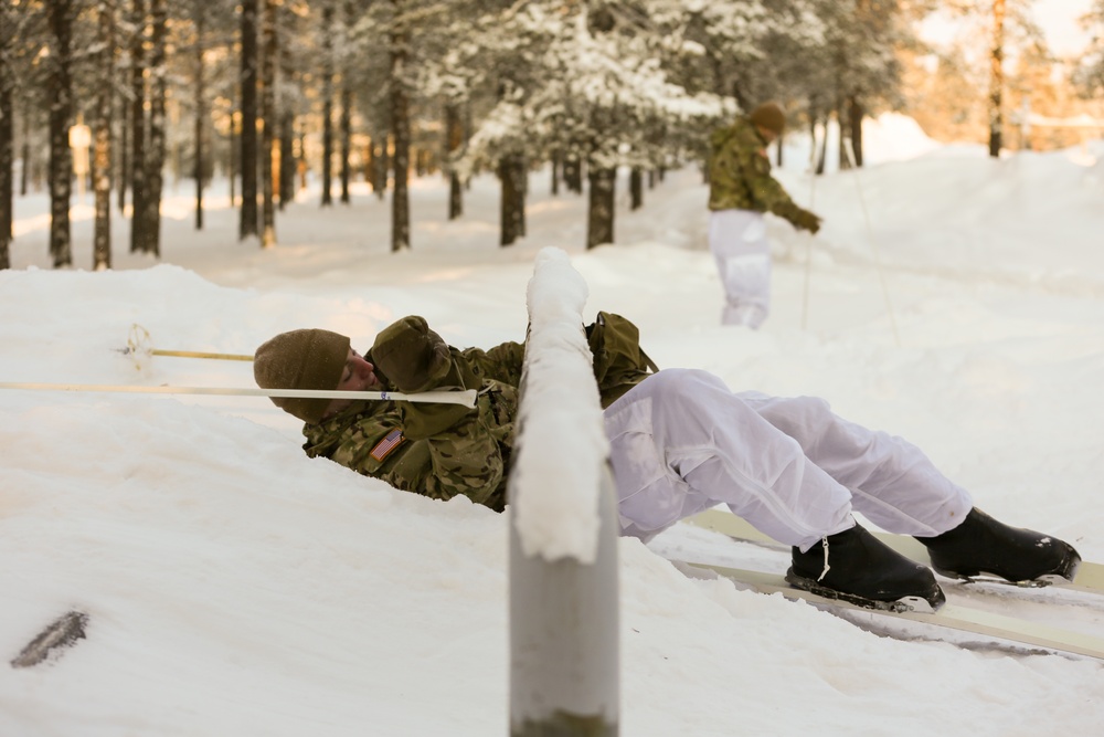 Charlie Troop, 3-71 Cavalry Regiment, 1BCT, 10th Mountain Division train with Finnish soldiers on a ski obstacle course during Defense Exercise North in Sodankyla Garrison, Finland, during Exercise Arctic Forge '23 on Feb. 21, 2023