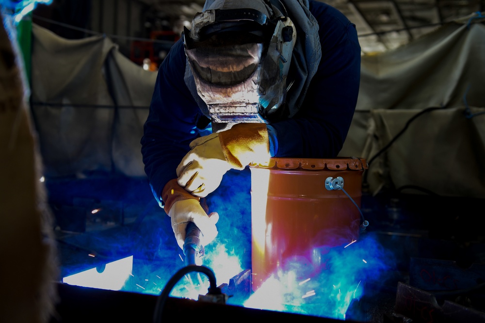 Contractor welds aboard the USS John C. Stennis