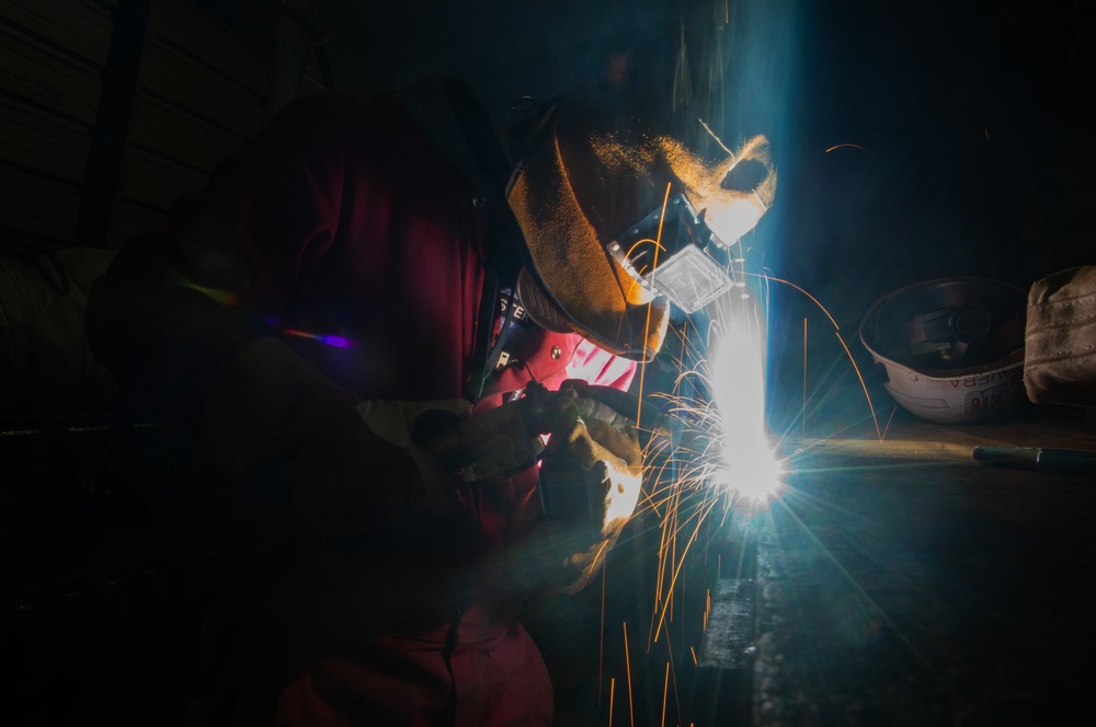 Contractor welds aboard the USS John C. Stennis