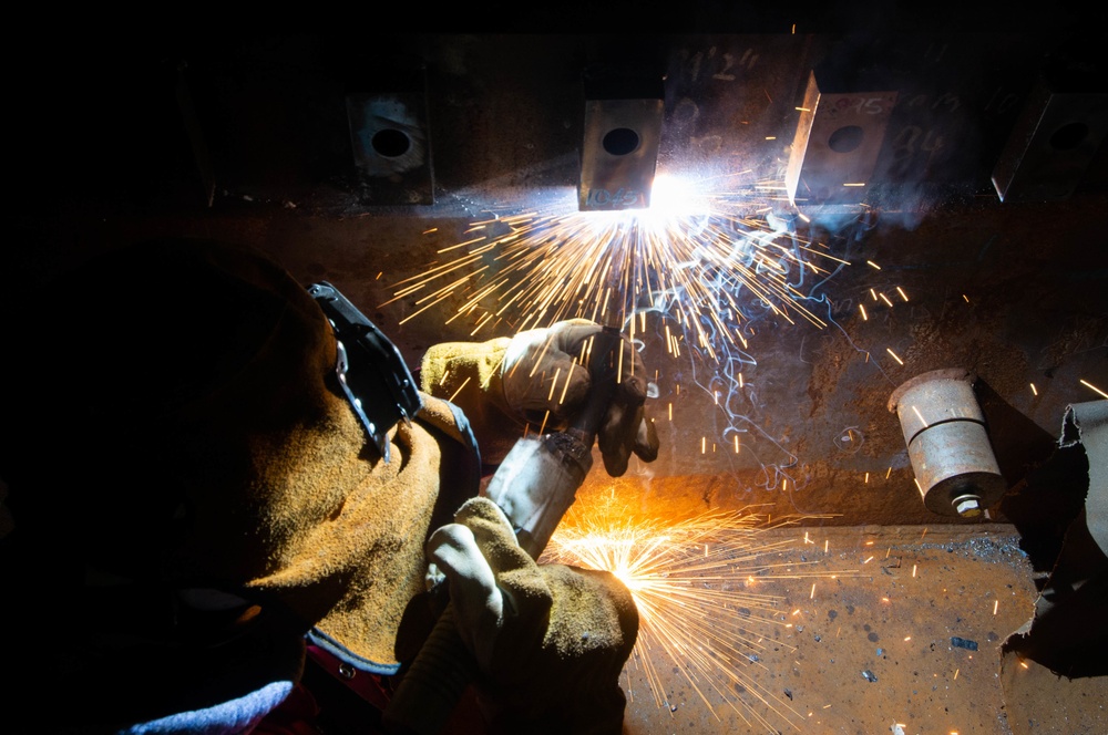 Contractor welds aboard the USS John C. Stennis