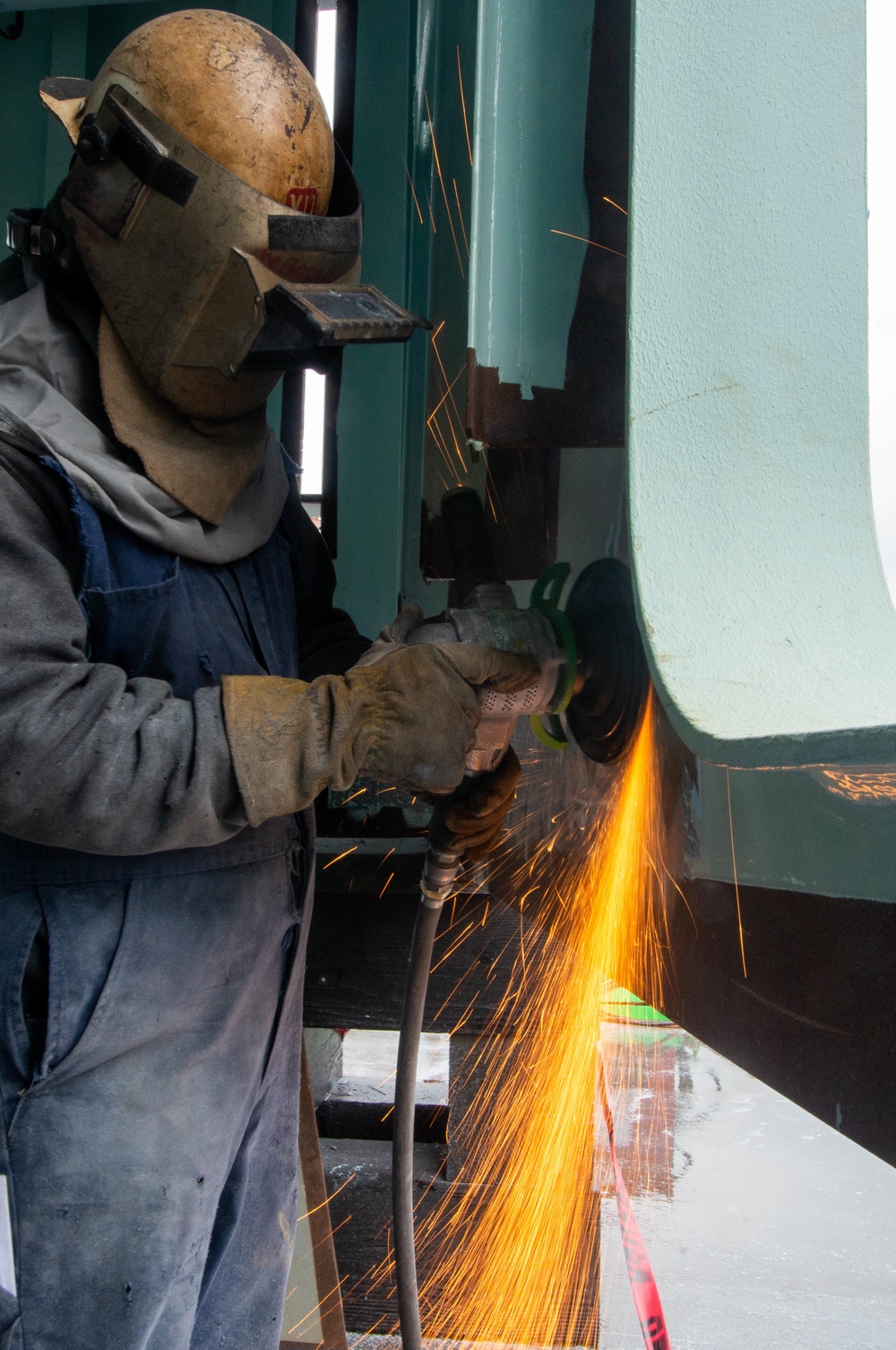 Contractor grinds aboard the USS John C. Stennis