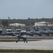 MQ-9 Reaper taxis past a Japanese Air-Self Defense Mitsubishi F-15J