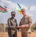 U.S. Army Capt. Joe Legros and Kenyan Defence Forces Capt. Jackie Wachira exchange gifts at JA23