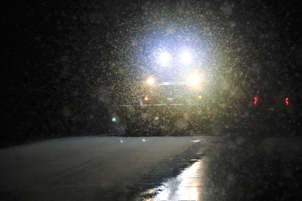 Snow removal operations after dark at Fort McCoy