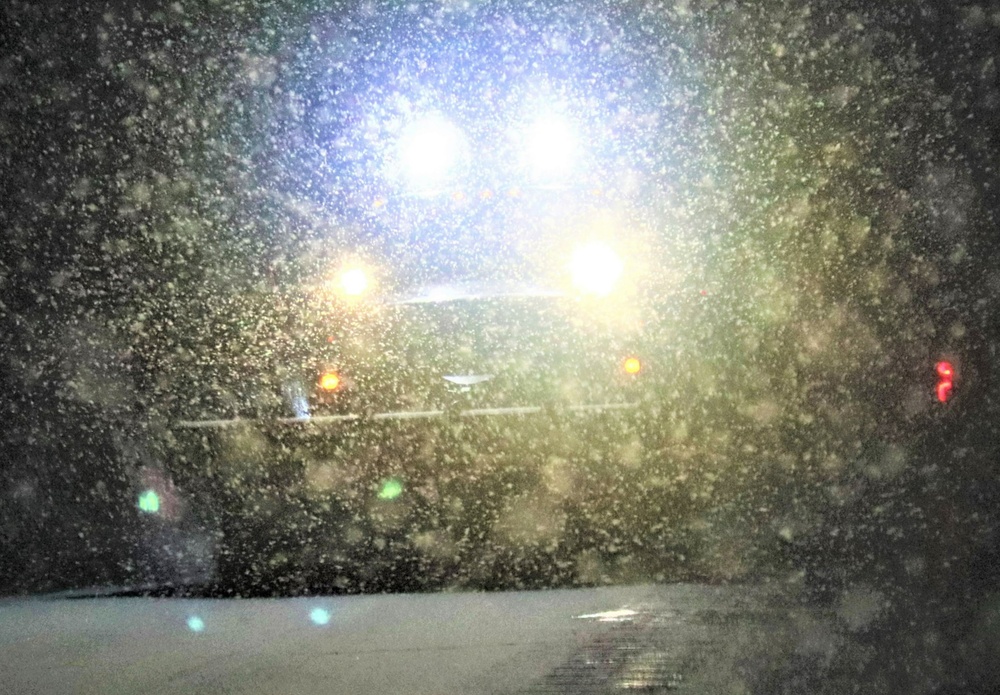 Snow removal operations after dark at Fort McCoy