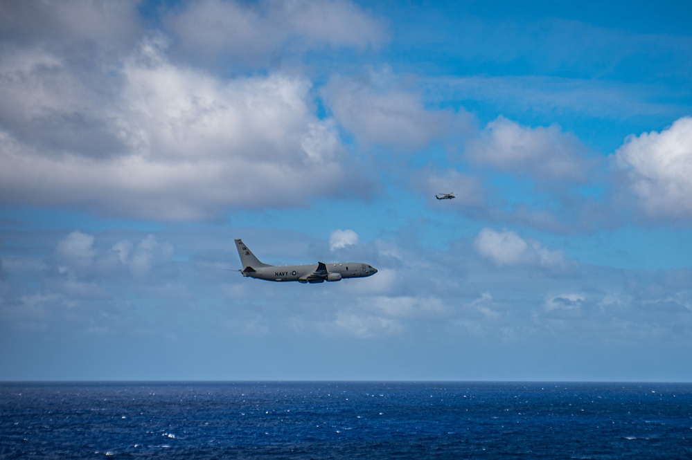 A P-8 Poseidon Flies By The Nimitz