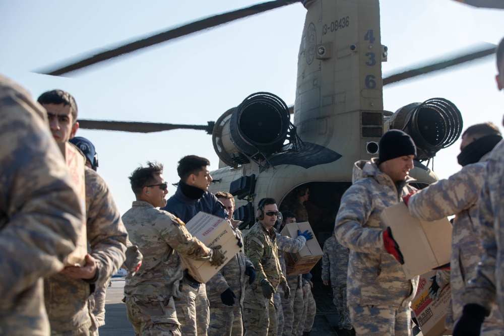 A US Army CH-47 Chinook is loaded with humanitarian aid supplies