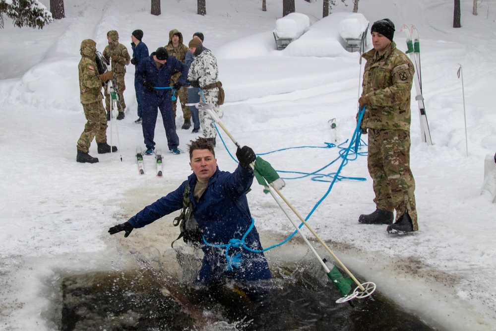3-71 Cavalry Regiment, 1BCT, 10th Mountain Division train on what to do if a soldier breaks through ice while crossing a river during Defense Exercise North in Sodankyla Garrison, Finland, during Exercise Arctic Forge '23 on Feb. 23, 2023