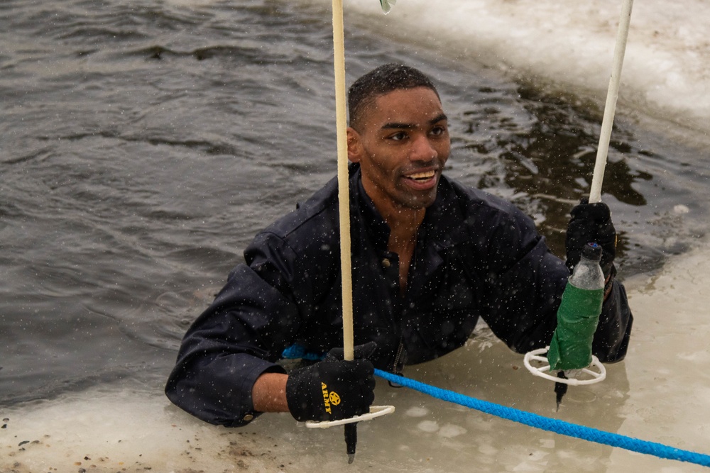 3-71 Cavalry Regiment, 1BCT, 10th Mountain Division train on what to do if a soldier breaks through ice while crossing a river during Defense Exercise North in Sodankyla Garrison, Finland, during Exercise Arctic Forge '23 on Feb. 23, 2023