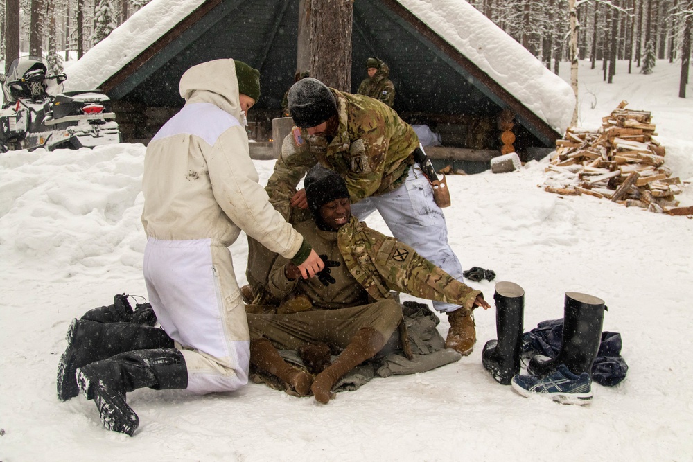 3-71 Cavalry Regiment, 1BCT, 10th Mountain Division train on what to do if a soldier breaks through ice while crossing a river during Defense Exercise North in Sodankyla Garrison, Finland, during Exercise Arctic Forge '23 on Feb. 23, 2023